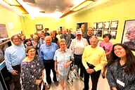 A large group of older adults, with some college-age people distributed among the group.